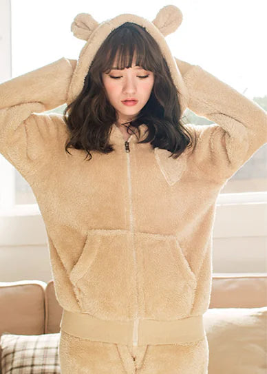 Woman wearing beige coral fleece pyjama set – warm winter loungewear