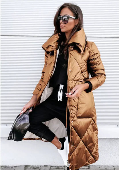 Woman wearing a long brown puffer coat against a white background