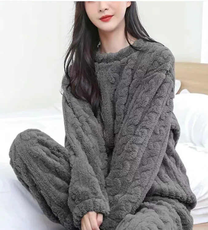 Person wearing a gray cable knit loungewear set on a white background