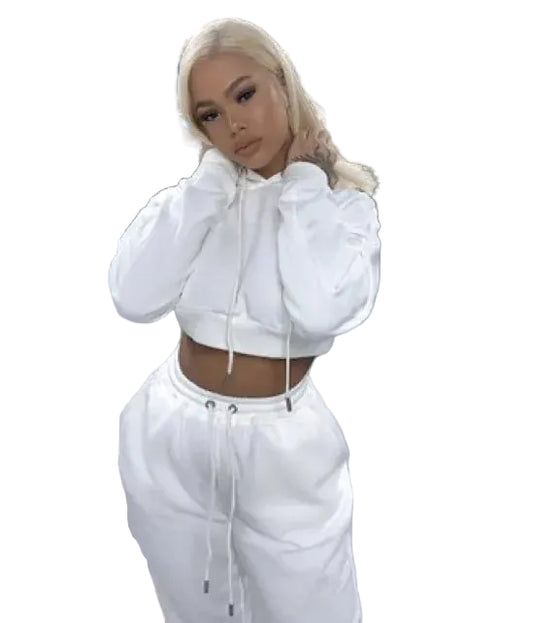 Person wearing a white hoodie and pants in an indoor setting