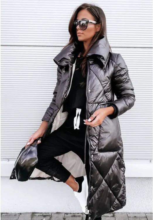 Woman wearing a long gray puffer coat in an urban setting