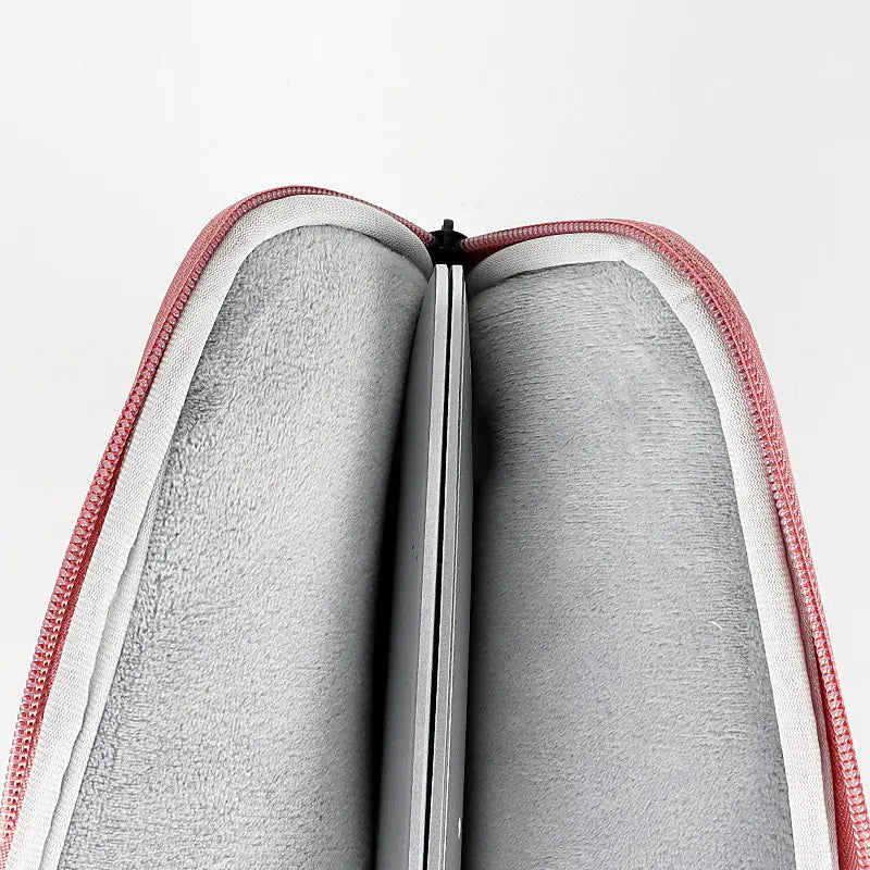 Gray fabric inside a red and white zippered case on a light gray background
