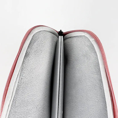 Gray fabric inside a red and white zippered case on a light gray background